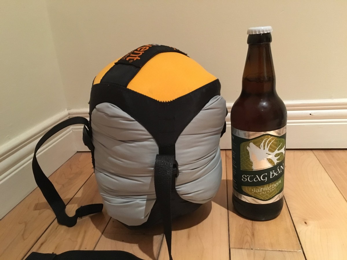 Jacket AND sleeping bag compressed. Beer bottle for scale