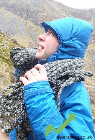 Snowy mountain hiking adventure with a climber in winter gear on a peak.