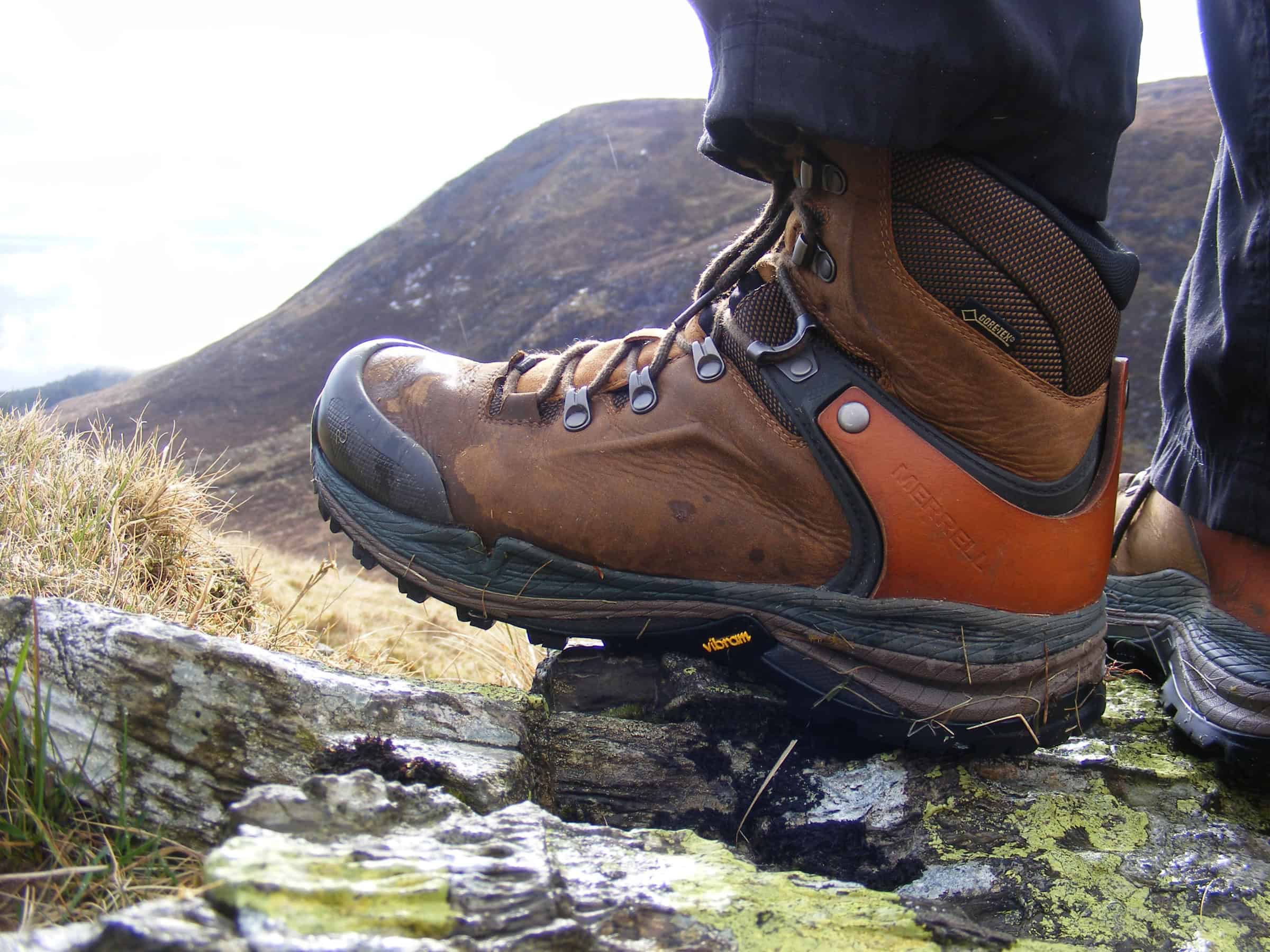 Merrell Crestbound Gore-Tex Boot Review Sturdy hiking boots on a rocky trail in the mountains, showcasing outdoor footwear ideal for trekking and adventure hiking.