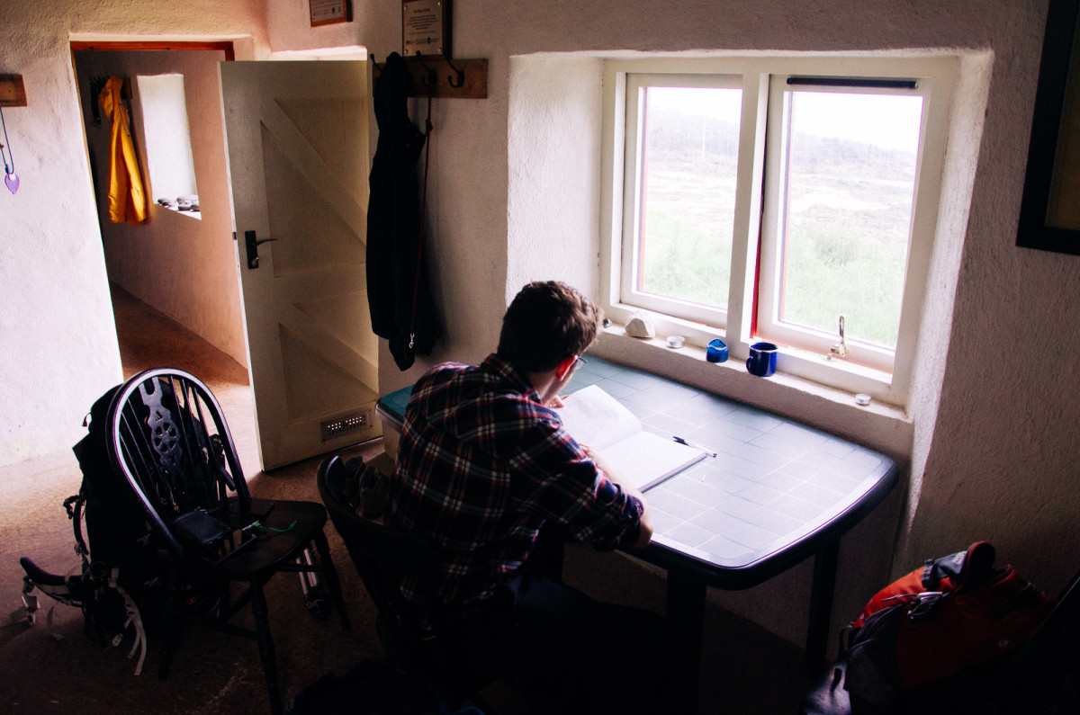 Signing the bothy logbook