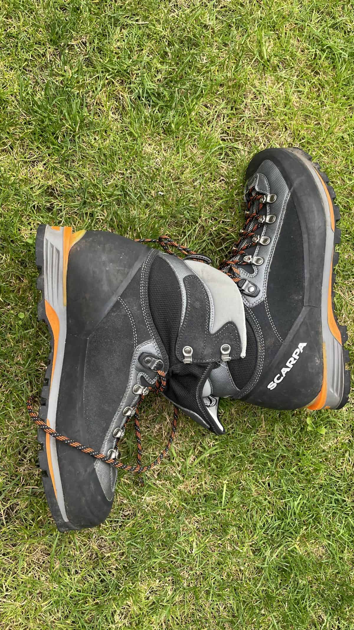 Durable hiking boots on green grass, ideal for outdoor trekking and mountain adventures, showcasing reliable outdoor footwear for hikers and explorers.