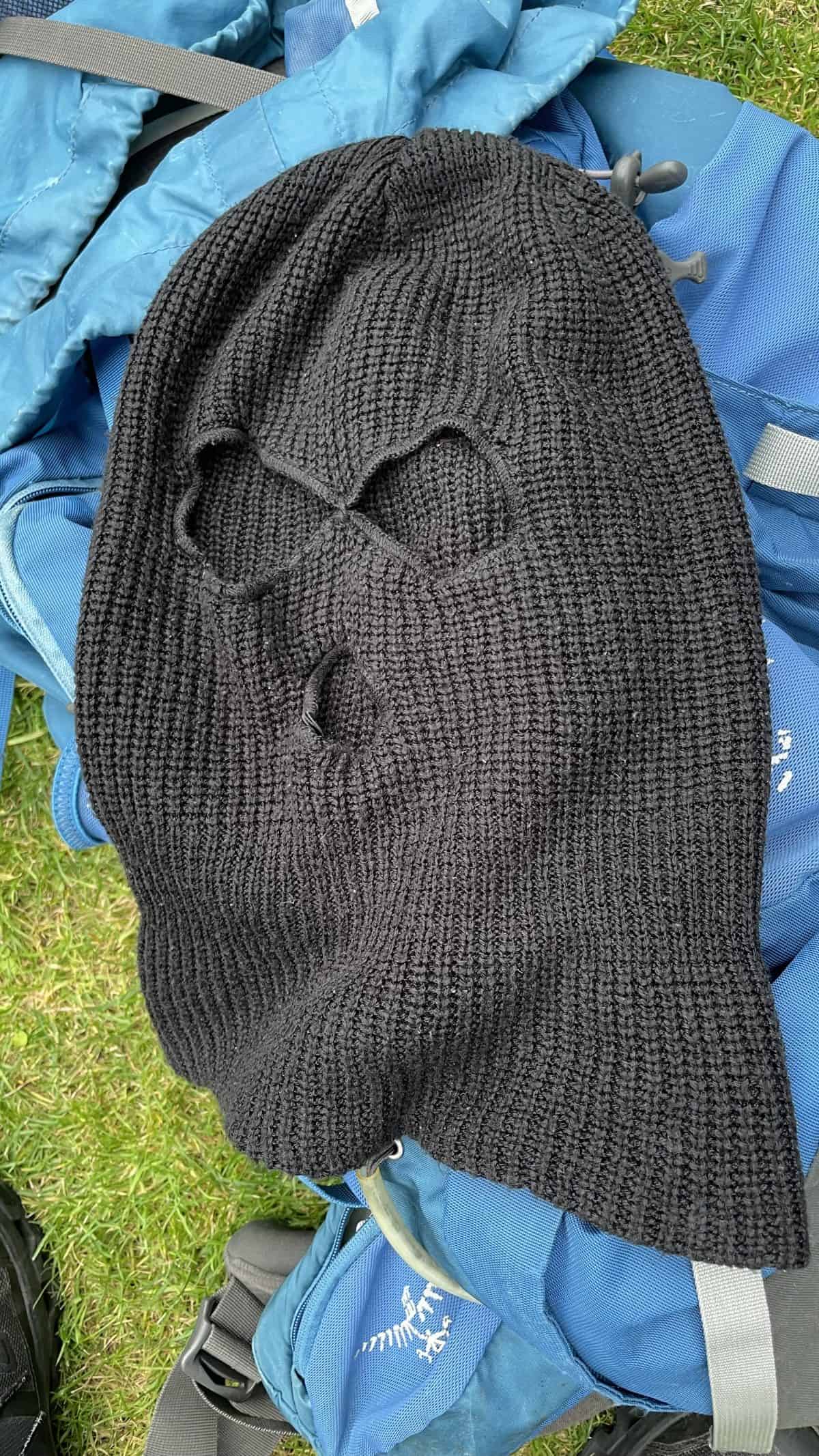 Warm black knitted beanie hat for hiking, outdoor activities, and cold weather adventures. Perfect for outdoor enthusiasts seeking durable, comfortable headgear.