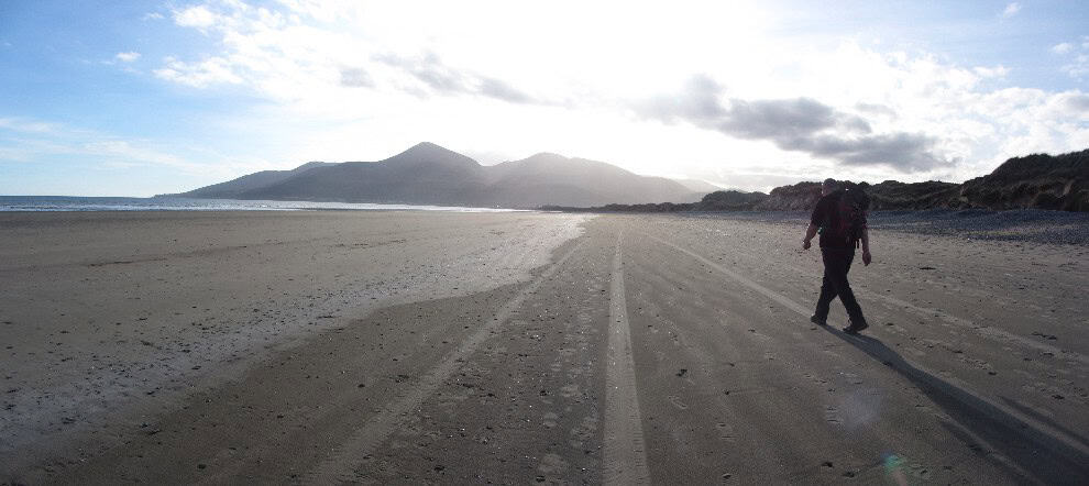 The Newcastle Challenge Trail Secluded beach with mountain backdrop, ideal for hiking, walking, and outdoor adventures, featuring sandy shores and scenic views.