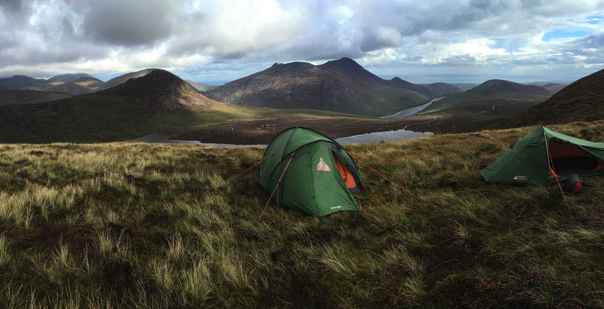 Video: Mourne AONB Uphill tents camping in a rugged mountain landscape with lakes and cloudy sky, perfect for hiking and outdoor adventures.