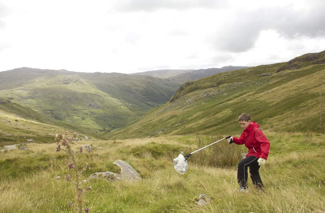 Keen & Respect the Mountains – Cleaning up the Mountains with Envirotrek Litter pickup in scenic mountain valley during a hiking trip, environmental cleanup in nature, eco-friendly activity, maintaining nature's beauty, outdoor adventure.